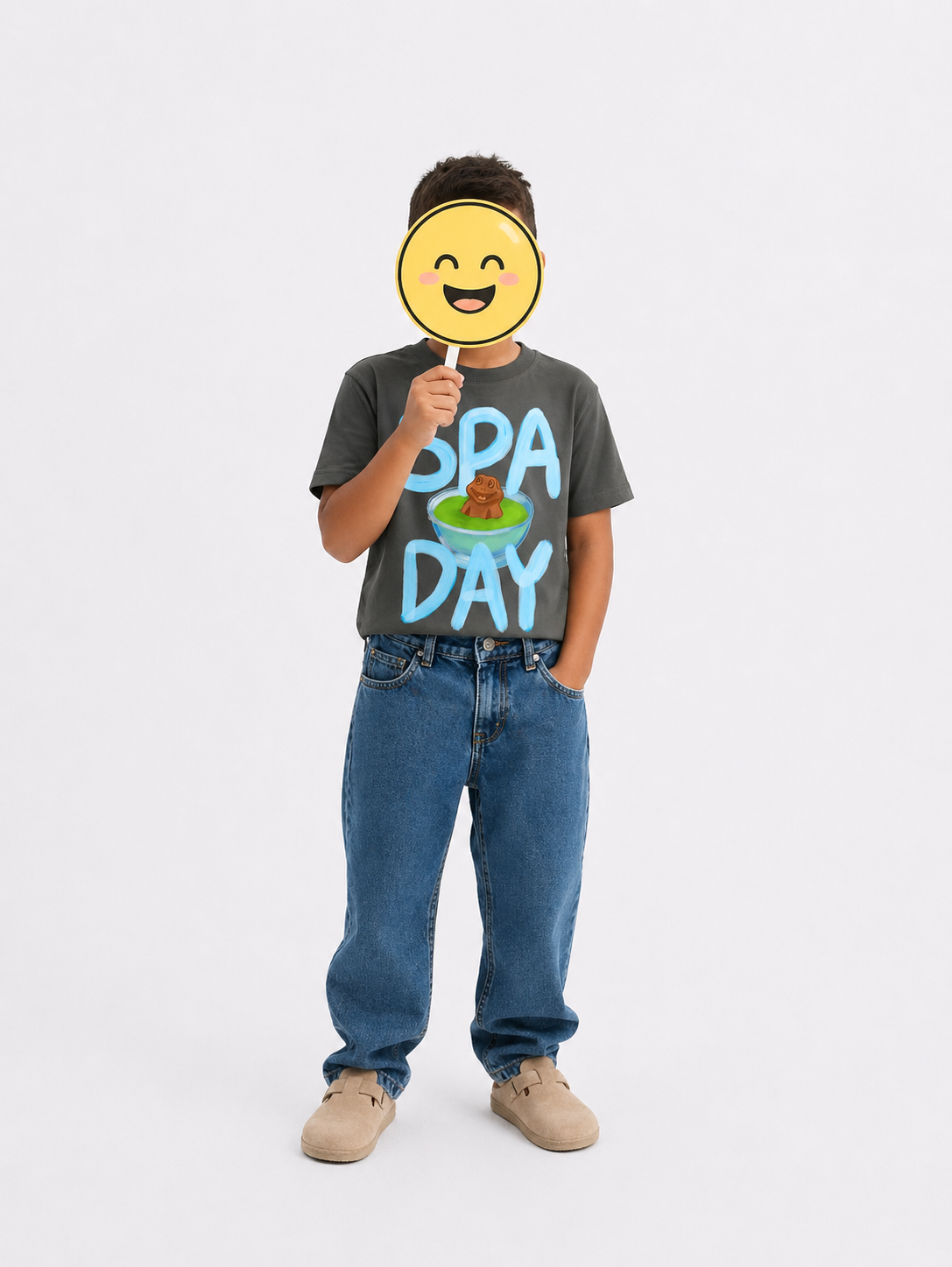 Boy's spa day chocolate frog t-shirt with hand-drawn art, boy is holding a smiley face sign